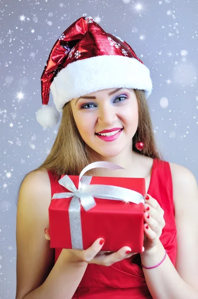 Beautiful young woman with Christmas gift — Stock Photo, Image