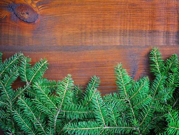 Branches of spruce on old wooden background — Stock Photo, Image