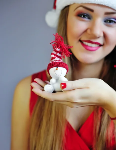 Woman holding out Snowman on the palm of her hand towards the vi — Stock Photo, Image