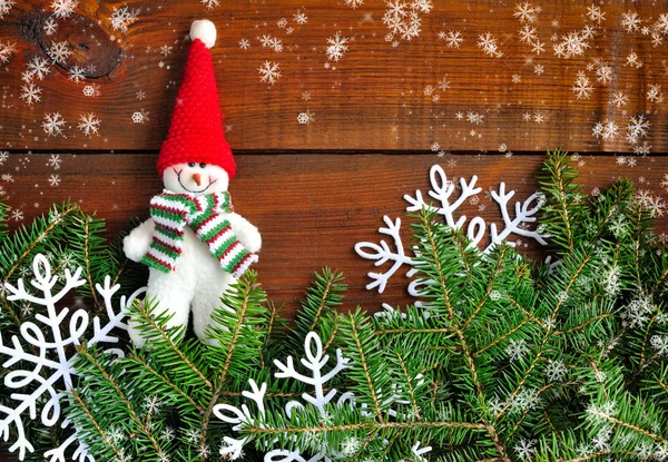 Bonhomme de neige avec les branches de sapin sur fond de bois — Photo