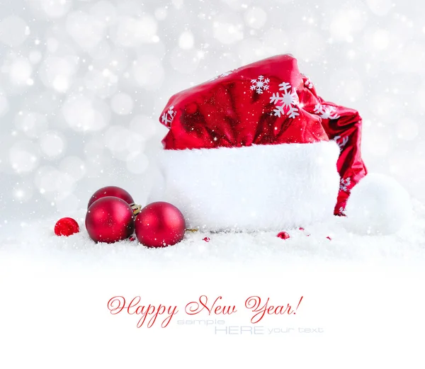 Santa hat with Christmas balls on snow — Stock Photo, Image