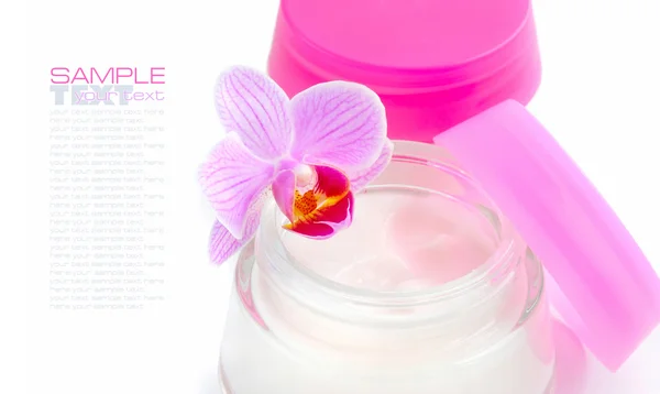 Face creams and beautiful orchid flowers on white background — Stock Photo, Image
