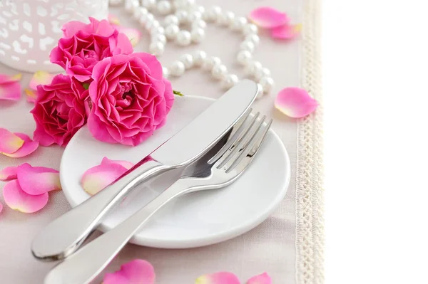 Romantic table setting with pink roses on a linen napkin Royalty Free Stock Images