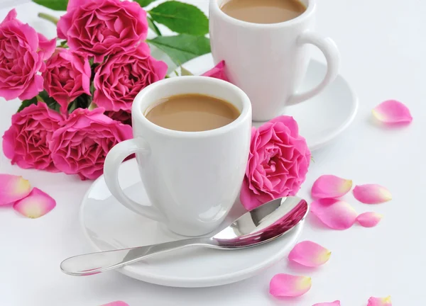 Cani de cafea și trandafiri roz pe fundal alb — Fotografie, imagine de stoc