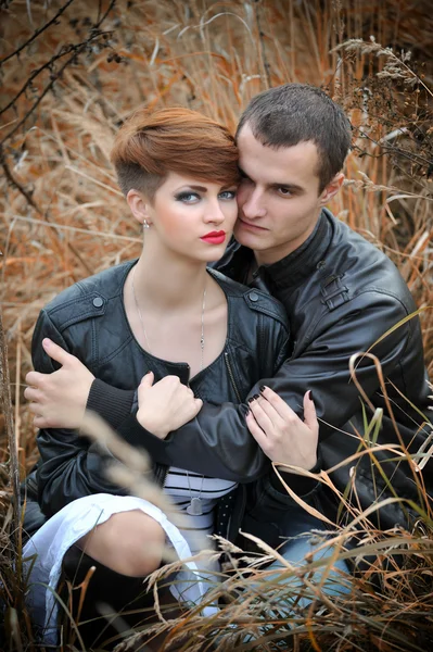 Loving couple on the autumn field — Stock Photo, Image