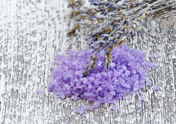 Salt for aromatherapy and dried lavenderon a wooden background Royalty Free Stock Images