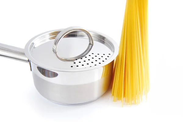 Bunch of spaghetti and pan on a white background — Stock Photo, Image