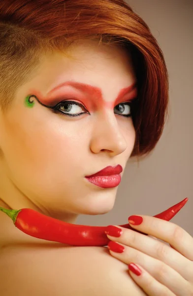 A kreatív piros smink gyönyörű nő portréja tartja chili paprika — Stock Fotó