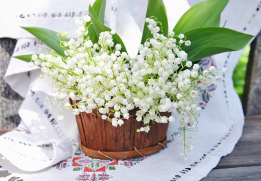 Basket with lilies of the valley (Convallaria majalis) clipart