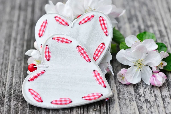 Spring Blossom and hearts over wooden background — Stock Photo, Image