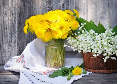 Bouquets of dandelions and lilies of the valley (Convallaria majalis) clipart