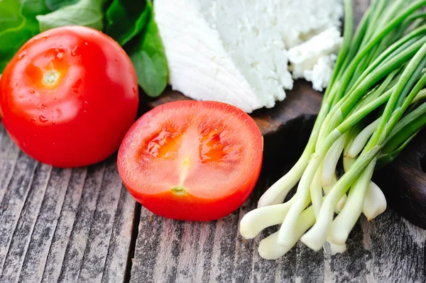 Tomatoes with onion and cheese — Stock Photo, Image