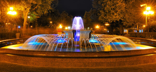 Colored water fountain at night