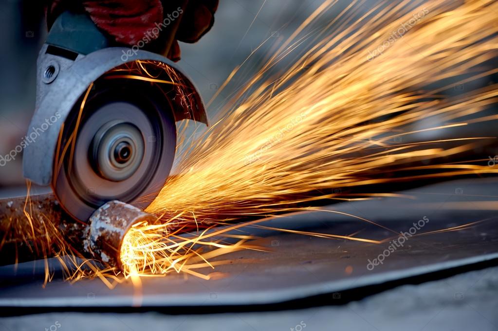 Worker cutting metal with grinder — Stock Photo © VolodymyrBur 48443003