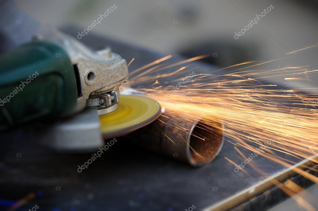 Worker cutting metal with grinder — Stock Photo © VolodymyrBur 50280297