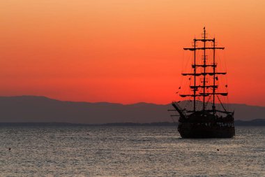 Sunset above ship in sea