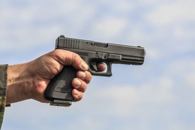 gun held in male hand