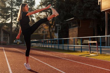 woman doing stretching exercise at city
