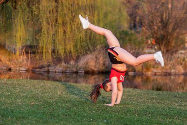 PRAGUE, CZECH REPUBLICK-23.03.2019: Young cheerleaders train in the park for a photo shoot at the end of the competition day.