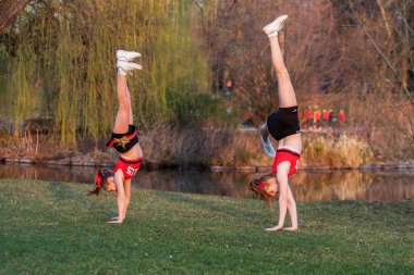 PRAGUE, CZECH REPUBLICK-23.03.2019: Young cheerleaders train in the park for a photo shoot at the end of the competition day.