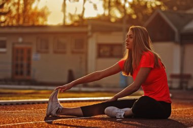 woman doing stretching exercise at city