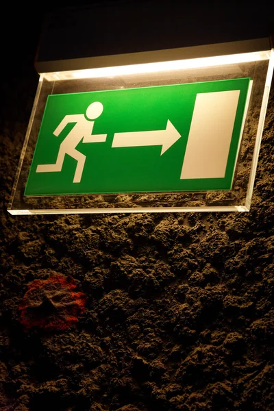 Lighted emergency exit sign. — Stock Photo, Image