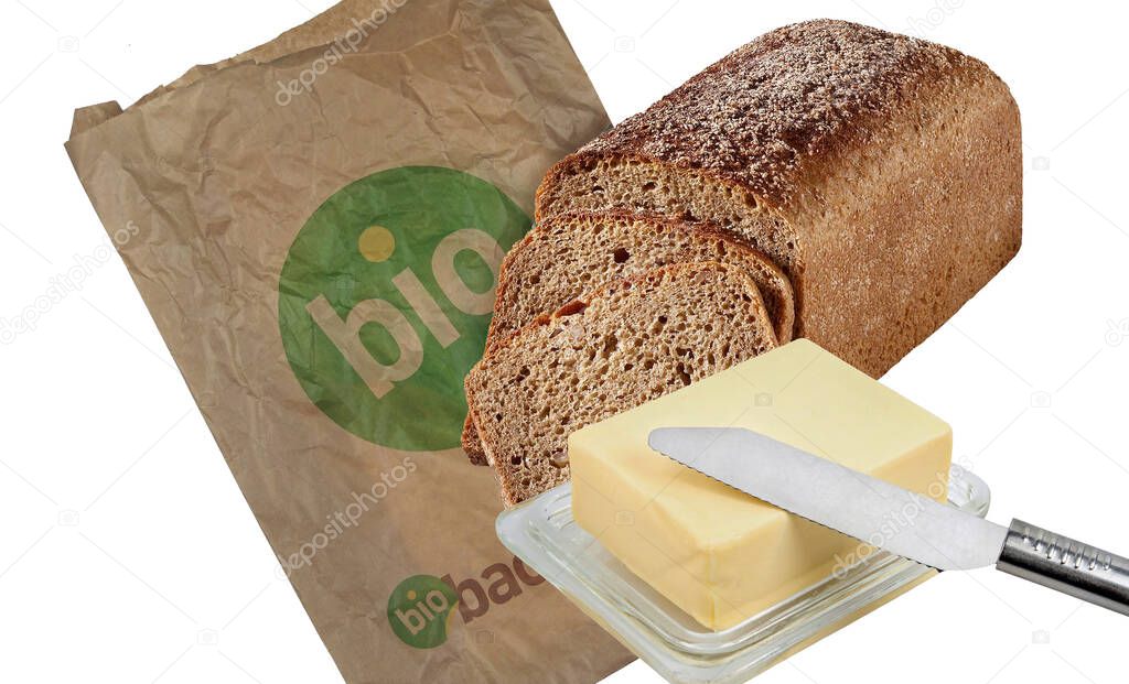 fresh bread and butter with a spoon on a white background