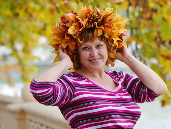 Happy mature woman in a wreath — Stock Photo, Image