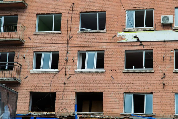 Broken, shelled windows. Buildings after being hit by missiles