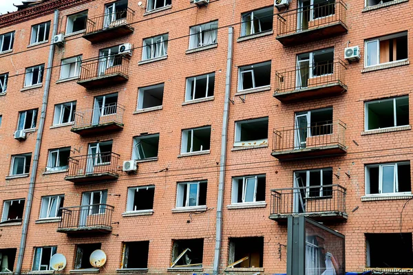 Broken, shelled windows. Buildings after being hit by missiles