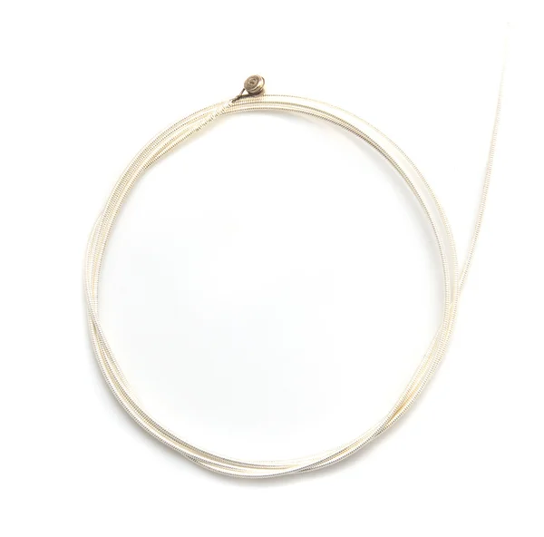 New string from a guitar on a white background. macro — Stock Photo, Image