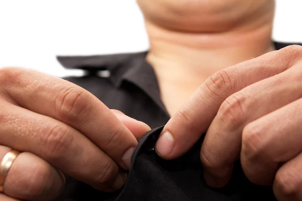 Man buttoning a shirt on a white background — Stock Photo, Image