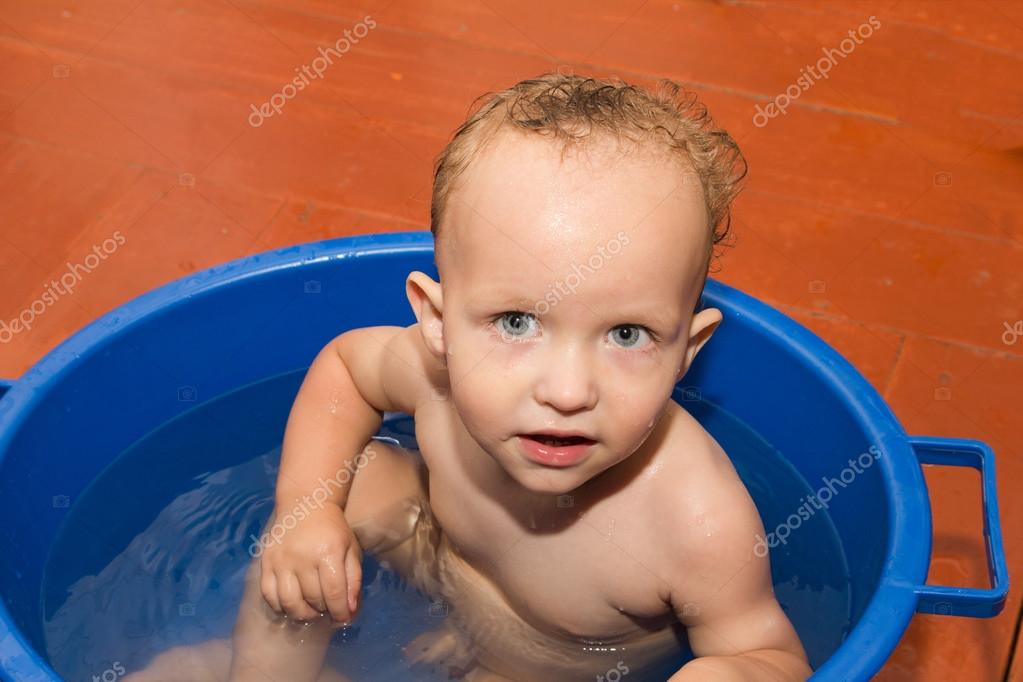 The little boy is bathed in a blue tub — Stock Photo © schankz 15838203