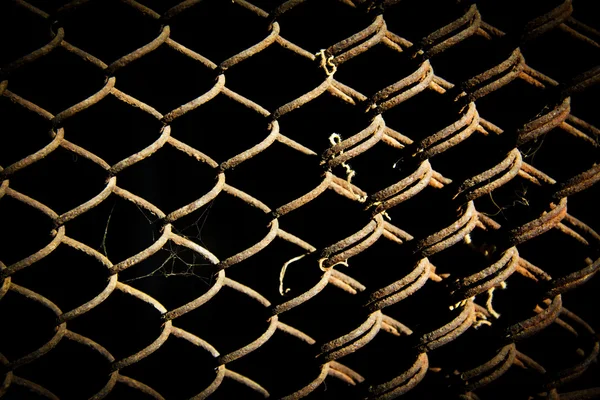 Rusty grid on a black background — Stock Photo, Image