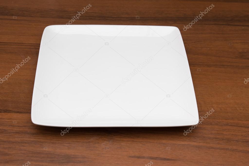 white plate on a wooden background