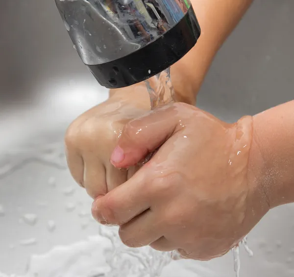 boy washes his hands