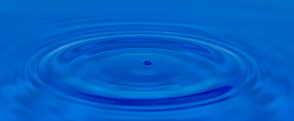 Druppel water in blauw — Stockfoto