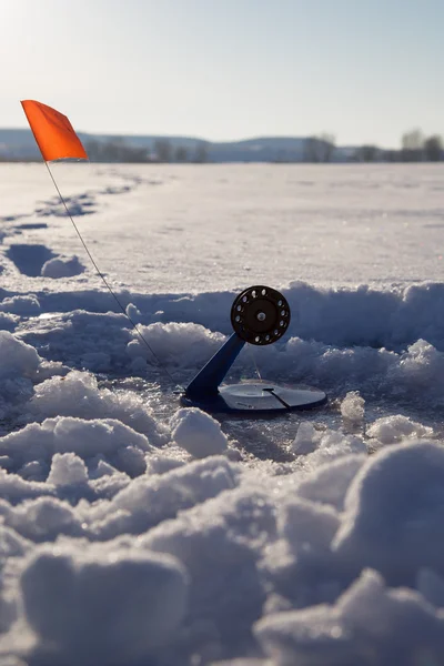 Fishing line in hole drilled in ice — Stock Photo, Image