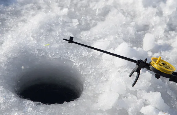 Fishing line in hole drilled in ice — Stock Photo, Image