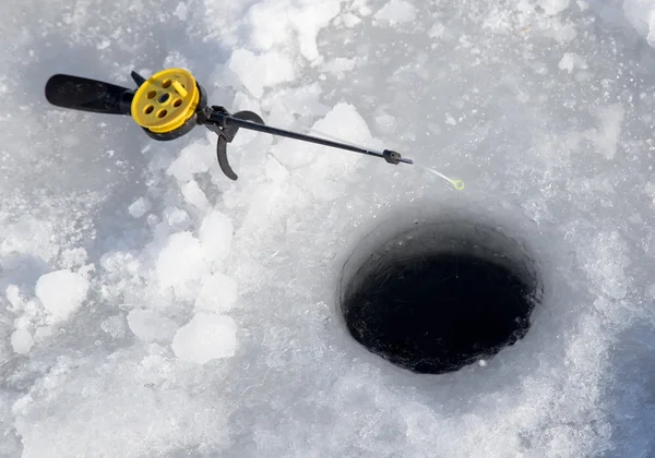 Fishing line in hole drilled in ice — Stock Photo, Image