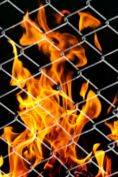 Fire in a metal grid — Stock Photo, Image