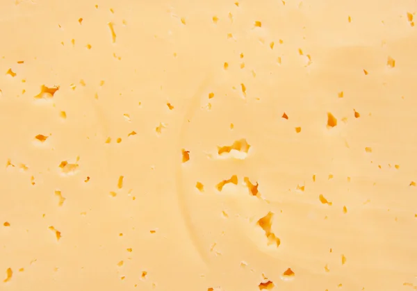 Background of fresh yellow Swiss cheese with holes — Stock Photo, Image