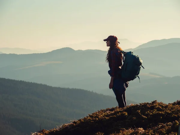 Mulher caminhante com mochila no topo de uma montanha — Fotografia de Stock