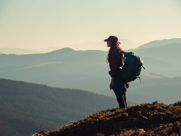 Hiker Woman with Backpack on Top of a Mountain