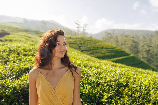 Woman traveler portrait against tea plantations landscape background Stock Photo