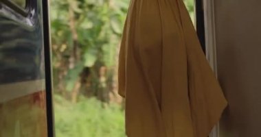Travel and Exploration of Tourist Woman by Train to Famous Landmarks in Sri Lanka. Romantic young traveler woman enjoying extreme fun train ride from Ella to Kandy among villages and jungles in the