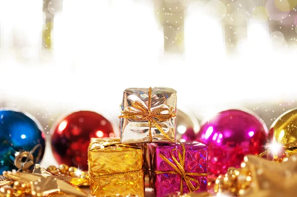 Christmas background with gifts and baubles — Stock Photo, Image