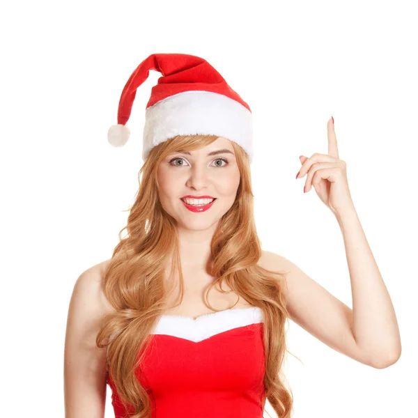 Krásná žena nosí Santa klobouk poukazují na copyspace — Stock fotografie