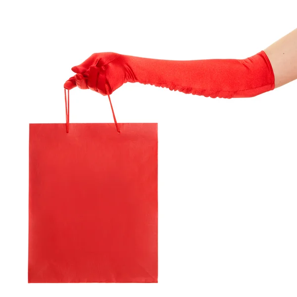 Hand in red gloves holding bag isolated over white background — Stock Photo, Image