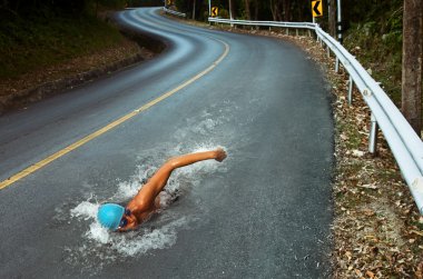 Strong Man Swim On Asphalt Road clipart